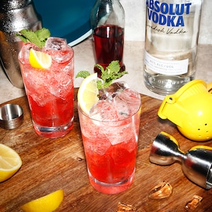 a picture of two red cocktails on a table